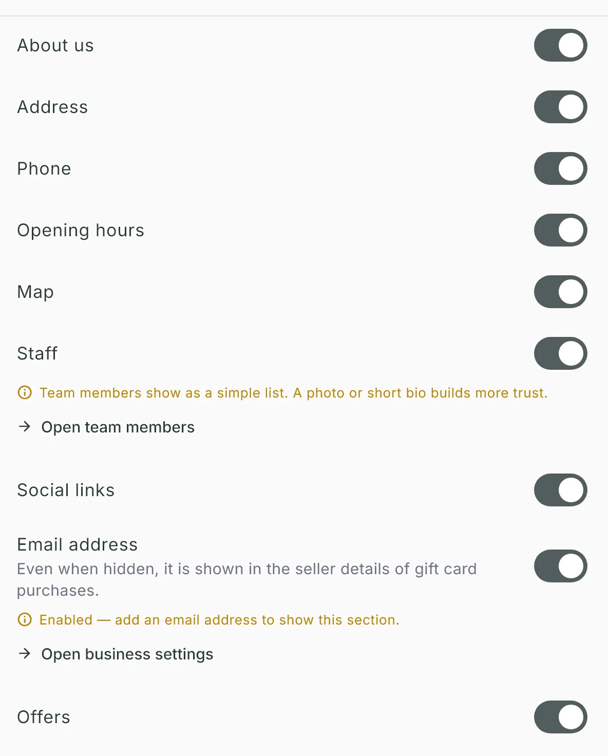 The nine Section visibility switches turned on; a photo tip under Staff, and under Email address a warning that no email address is set, with an Open business settings link